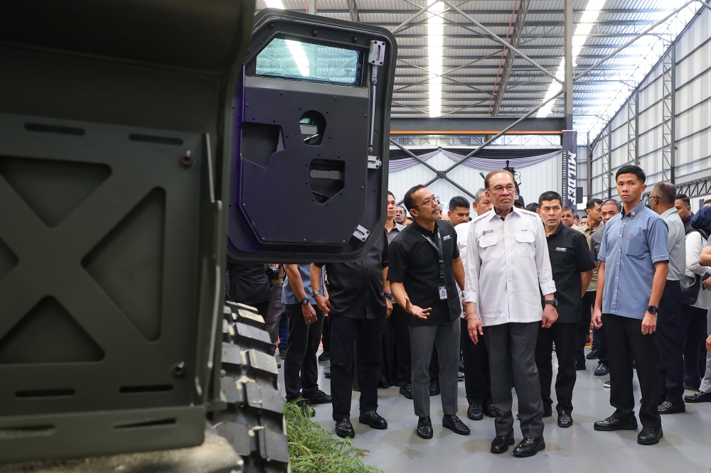Prime Minister Datuk Seri Anwar Ibrahim views a Tarantula high-mobility armoured vehicle during a visit to the Mildef Technologies plant in Sendayan, Seremban, on August 23, 2025. — Bernama pic