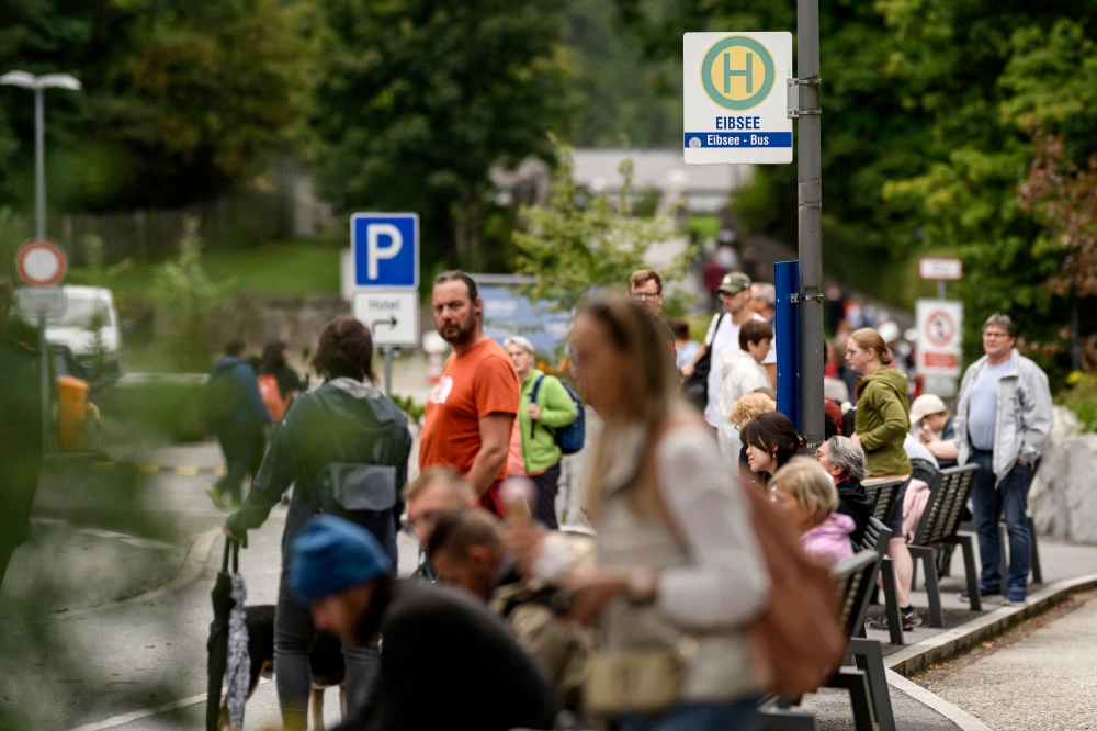 A picture-perfect Alpine mountain lake in Germany draws so many visitors every summer that the first thing they see is crowded busses, traffic jams and a packed-out carpark. — APF pic