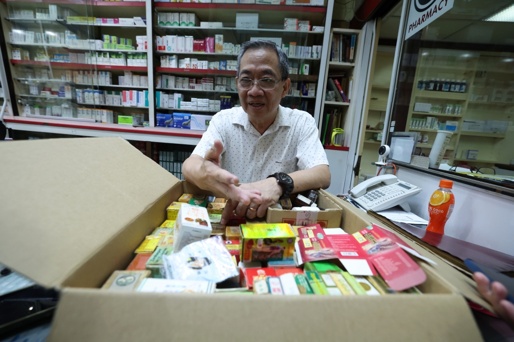Third-generation custodian Ng Chee Yat shows some prohibited medicines he received from customers at the 83-year-old Kedai Ubat Kien Fatt in Kuala Lumpur recently. — Bernama pic