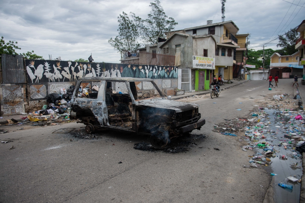 This file picture shows a burnt-out car is seen during a protest against insecurity in Port-au-Prince, Haiti on April 16. — AFP pic