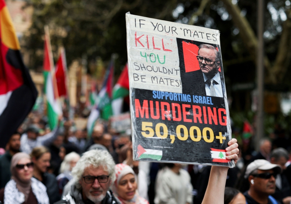 A demonstrator holds a placard as they take part in the 'Nationwide March for Palestine' protest in Sydney, Australia, August 24, 2025. — Reuters pic