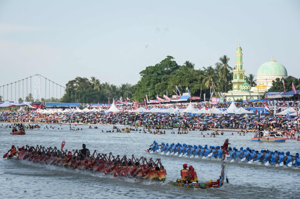 Participants compete during the Pacu Jalur longboat race festival on the Kuantan River in Kuantan Singingi Regency, Riau Province, on August 22, 2025. — AFP pic