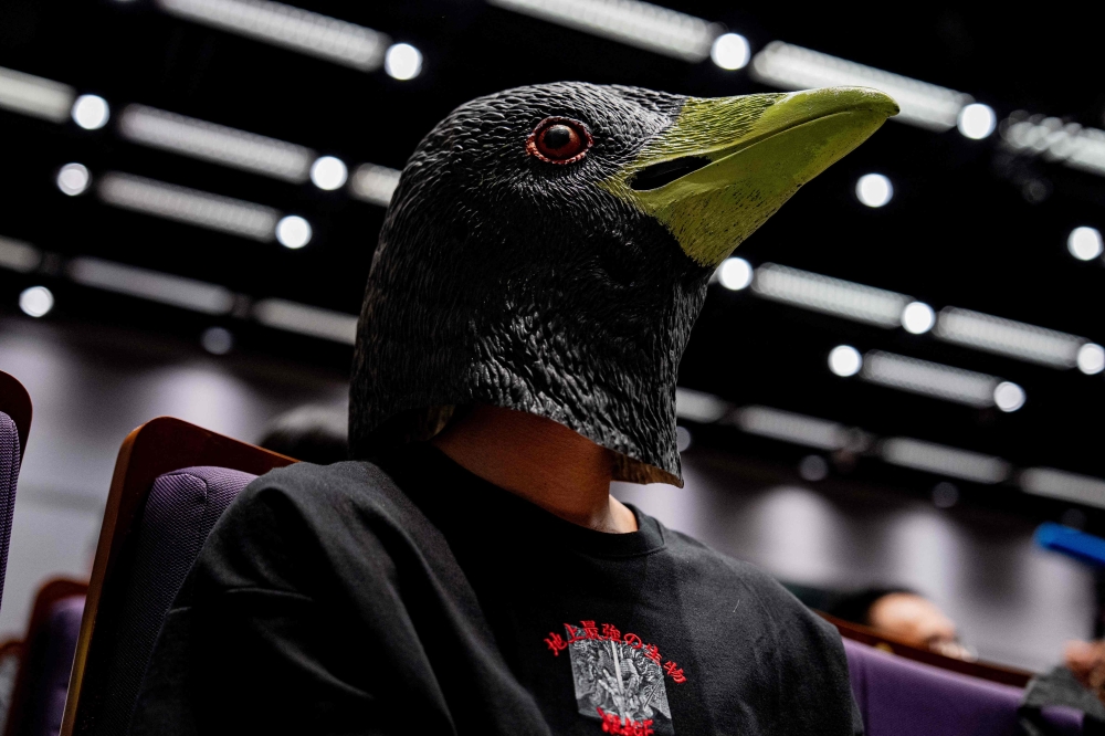 A participant wears a bird-themed mask. — AFP pic