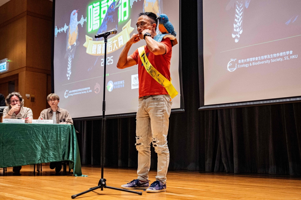 A participant, wearing a bird-themed decoration, mimics bird calls during the Hong Kong Bird Watching Society’s bird call competition. — AFP pic