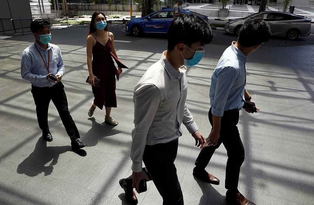 Office workers wearing face masks take their lunch break at the central business district amid the Covid-19 outbreak in Singapore on June 2, 2020. — Reuters pic