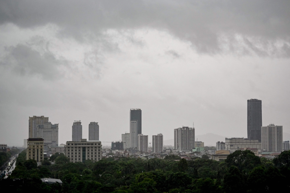 Storm clouds form above buildings in Vinh city, Nghe An province, on August 25, 2025, before Typhoon Kajiki makes landfall in Vietnam. — AFP pic