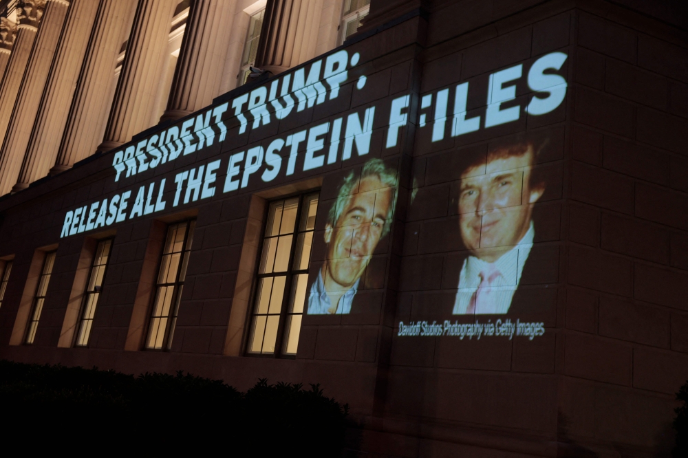 An image of US President Donald Trump and Jeffrey Epstein, along with the words “President Trump: Release All the Epstein Files”, is projected onto the US Department of Commerce headquarters in Washington, DC, on July 18, 2025. — AFP pic