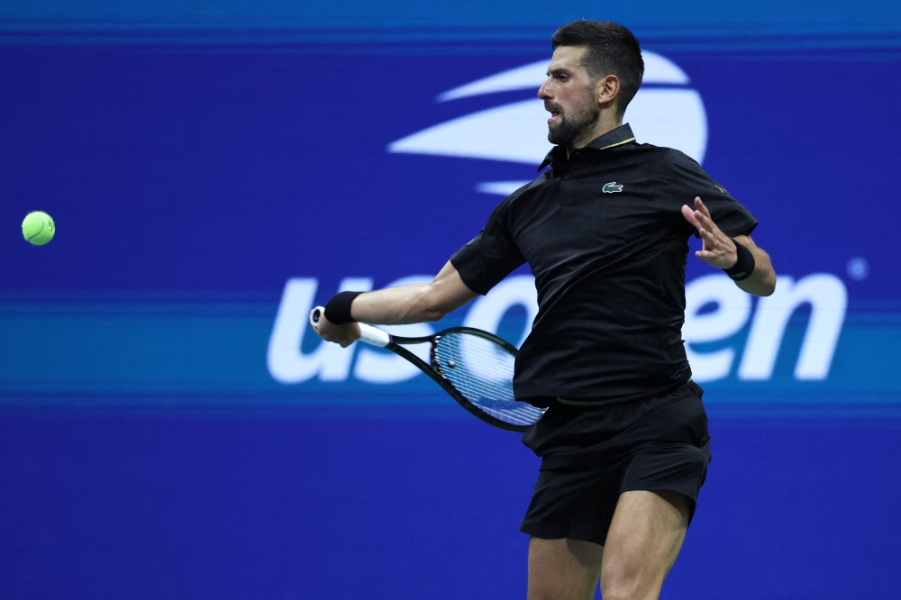 Novak Djokovic (SRB) hits the ball against Learner Tien (USA) (not pictured) on day one of the 2025 US Open tennis tournament at USTA Billie Jean King National Tennis Centre August 24, 2025. — Amber Searls-Imagn Images/Reuters pic