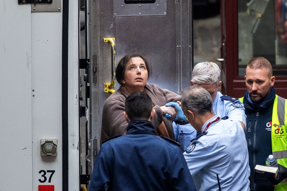 This handout picture taken and released by NewsWire on August 25, 2025 shows convicted murderer Erin Patterson (top left) arriving at the Supreme Court of Victoria ahead of her sentencing in Melbourne. The only guest to survive a toxic mushroom lunch with Australian murderer Erin Patterson said on August 25 he feels ‘half alive’ without his wife, who was one of the three victims. — Jason Edwards/NewsWire/AFP pic