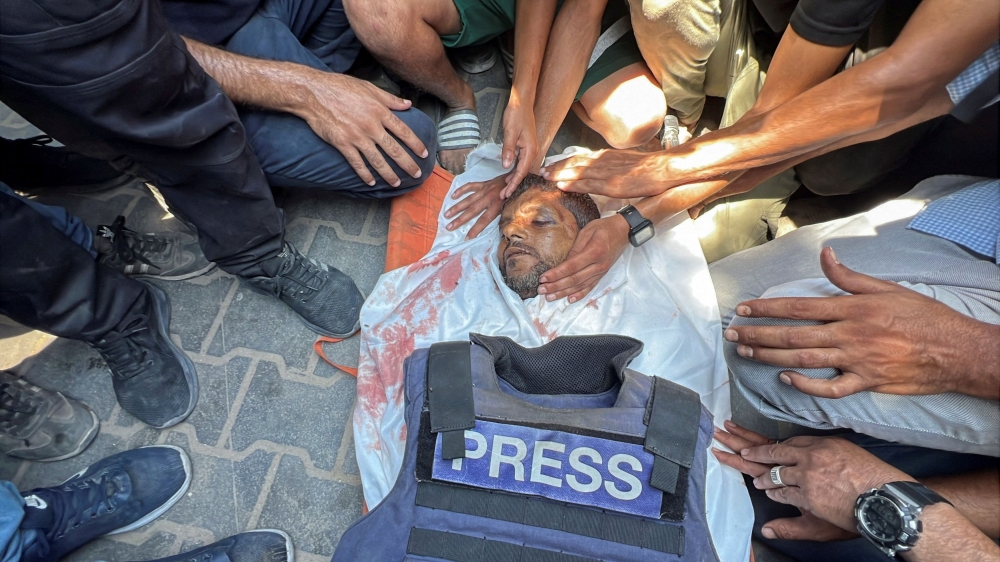 Mourners gather around the body of Palestinian cameraman Hussam al-Masri, who was killed in Israeli strikes on Nasser hospital in Khan Younis, southern Gaza Strip, on August 25, 2025. — Reuters pic