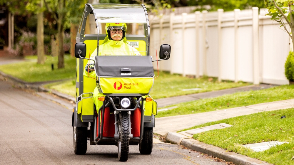 An AusPost postman rides a electric trike in this undated promotional image. — AusPost pic