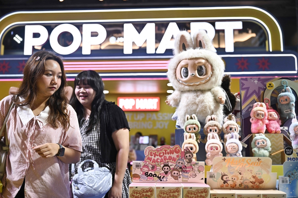 People look at Labubu toys at a Pop Mart pop-up store in Bangkok May 6, 2025. The collectibles may be trending, but Beijing says stimulus, not toys, is key to reviving China’s economy. — AFP pic