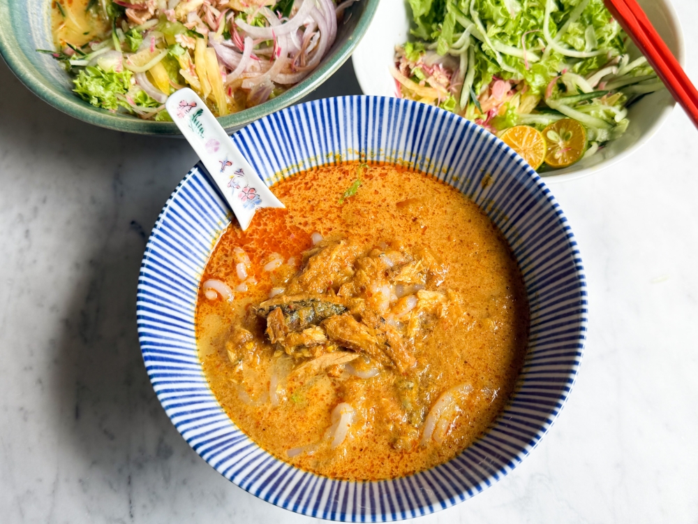 Unadorned, their Penang Nonya Lemak Laksa is creamy with chunks of deboned fish and soft fresh rice noodles. — Picture by Lee Khang Yi
