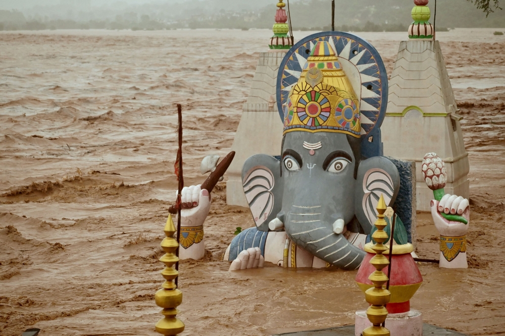 Water from the overflowing Tawi River floods a temple of the Hindu elephant god Ganesh, the deity of prosperity, following heavy rain in Jammu, Indian Kashmir, August 26, 2025. — Reuters pic