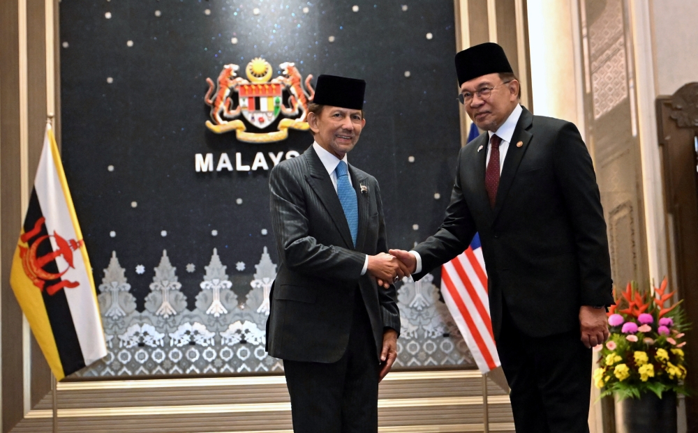 The Sultan of Brunei, Sultan Hassanal Bolkiah (left), shakes hands with Prime Minister Datuk Seri Anwar Ibrahim (right) during the 26th Malaysia-Brunei Annual Leaders’ Consultation (ALC) at the Seri Perdana Complex August 27, 2025. — Bernama pic
