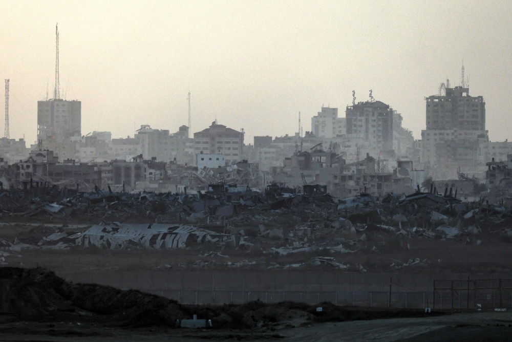 This picture taken from a position on the Israeli border with the Gaza Strip shows destroyed buildings in the embattled territory on Aug 27, 2025. — Bernama pic