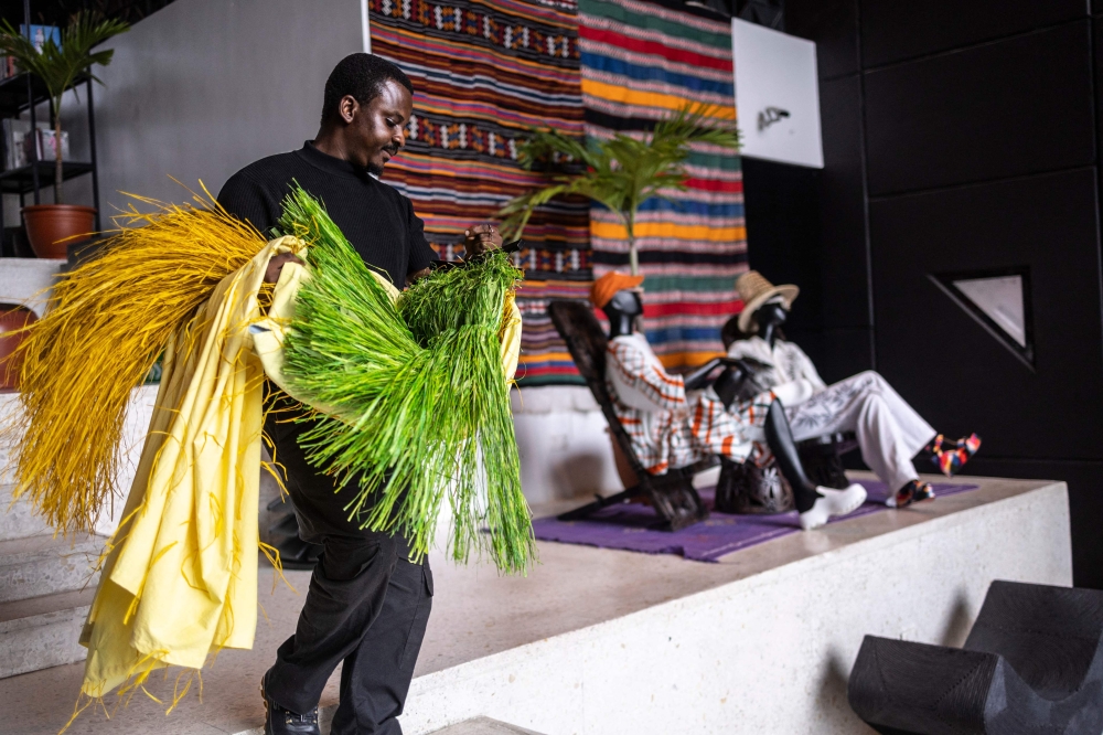 An employee carries clothes as he walks inside Alara concept store in Lagos. — AFP pic 