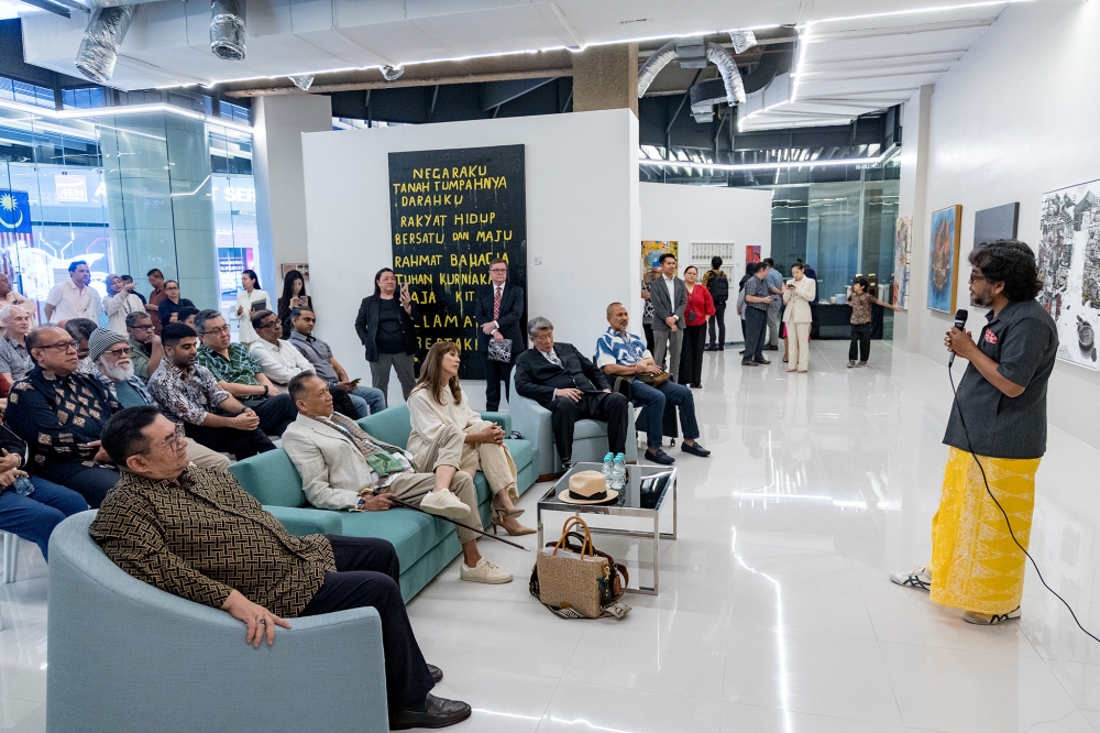 Artist Azzaha Ibrahim (right) speaks at the launch of Ruang Teduh art gallery at Exchange 106, Tun Razak Exchange in Kuala Lumpur on August 28, 2025. — Picture by Firdaus Latif