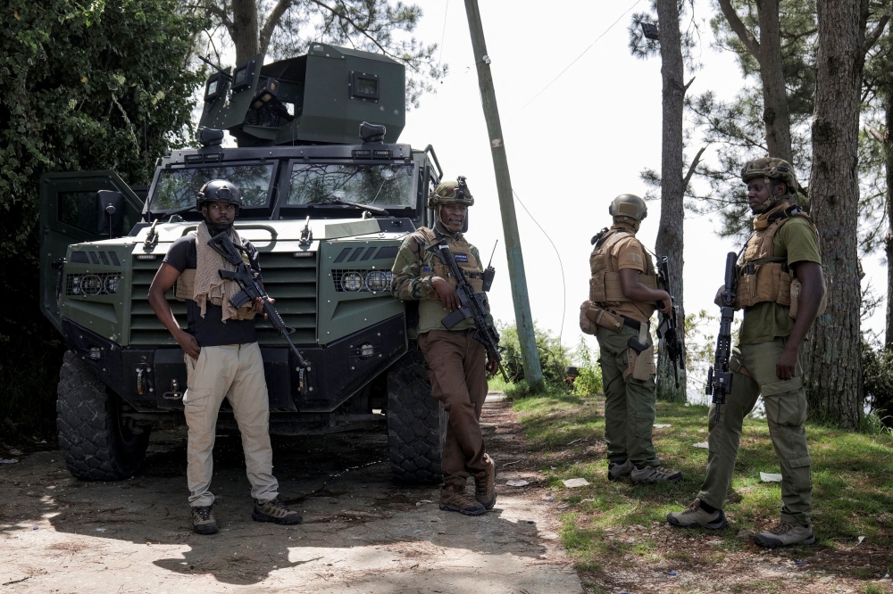 Kenyan security forces stand near an armoured vehicle after an operation by the Haitian National Police and the Multinational Security Support (MSS) mission to recapture the Teleco communications site and surrounding community from armed gangs, on the outskirts of Port-au-Prince, in Kenscoff, Haiti August 26, 2025.