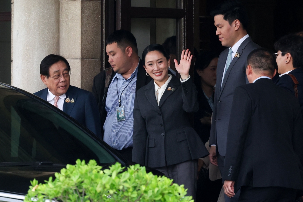 Thailand's Paetongtarn Shinawatra, who was dismissed as prime minister, waves as she leaves the Government House  in Bangkok August 29, 2025. Thailand’s ruling alliance remains together and the Pheu Thai party is confident it will form a government and remain at the core of the coalition, the country’s acting premier said today. — Reuters pic 