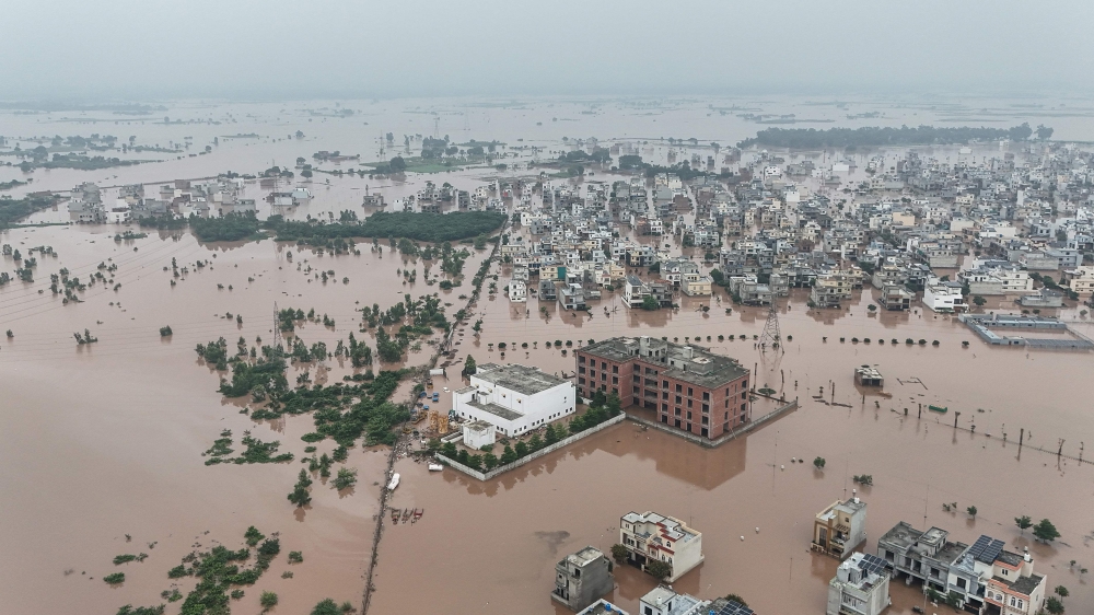 This aerial view shows partially submerged residential buildings following the overflowing of the Ravi River in Lahore on August 30, 2025. — AFP pic