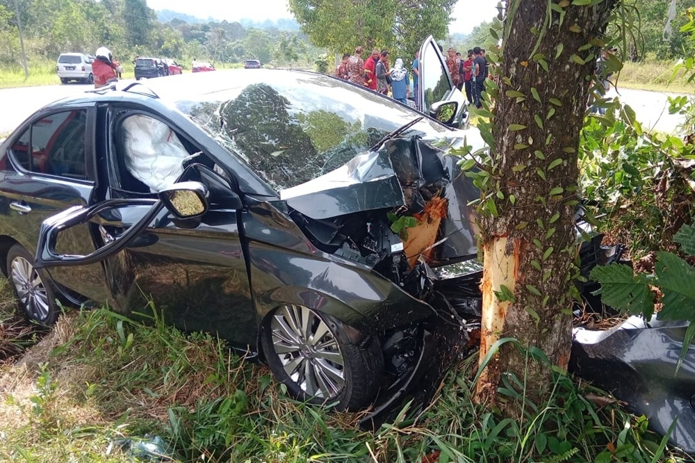 The badly damaged sedan at the scene. — Picture courtesy of Fire and Rescue Department 