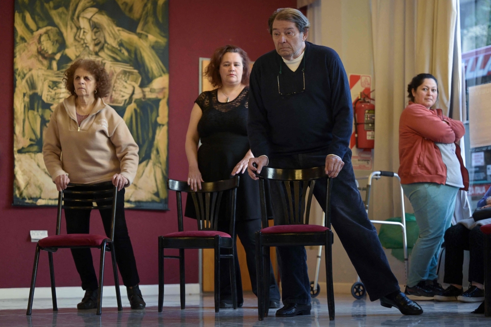 People suffering from Parkinson’s disease warm up during a tango therapy session in Buenos Aires August 26, 2025. — AFP pic