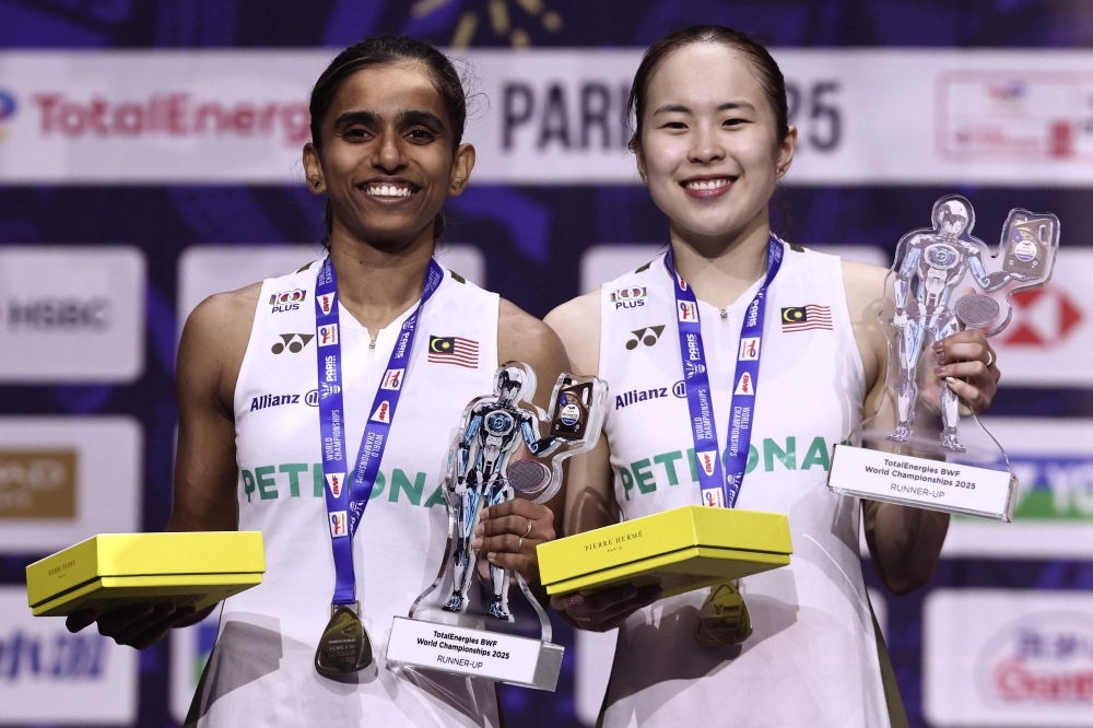 Silver medallists Malaysia’s Pearly Tan and M. Thinaah celebrate on the podium following the women’s doubles final match at the Badminton BWF World Championships in Paris August 31, 2025. — AFP pic
