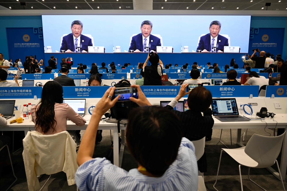Chinese President Xi Jinping is seen on a screen at the media centre during the opening ceremony of the Shanghai Cooperation Organisation (SCO) Summit in Tianjin September 1, 2025. — AFP pic