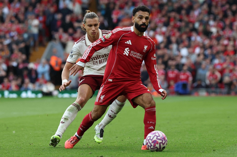 Arsenal’s Riccardo Calafiori shadows Liverpool’s Mohamed Salah during their Premier League match at Anfield in Liverpool August 31, 2025. — AFP pic
