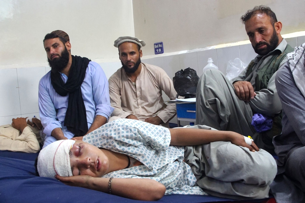 An injured Afghan boy (bottom) receives treatment at a hospital after an earthquake in Afghanistan’s Jalalabad September 1, 2025. — AFP pic