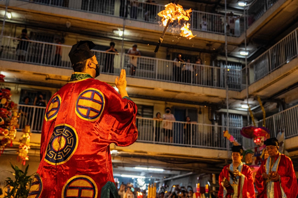 Taoist priests perform the 'Breaking the Hell's Gate' ritual during the Hungry Ghost or the Yu Lan festival at the Wah Fu Estate in Hong Kong on August 31, 2025. — AFP pic