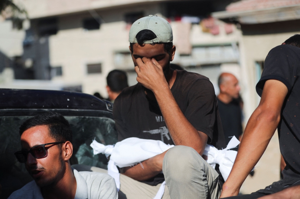 A man mourns during the funeral of Palestinians killed in overnight Israeli strikes, according to medics, at Al-Shifa Hospital in Gaza City September 1, 2025. — Reuters pic