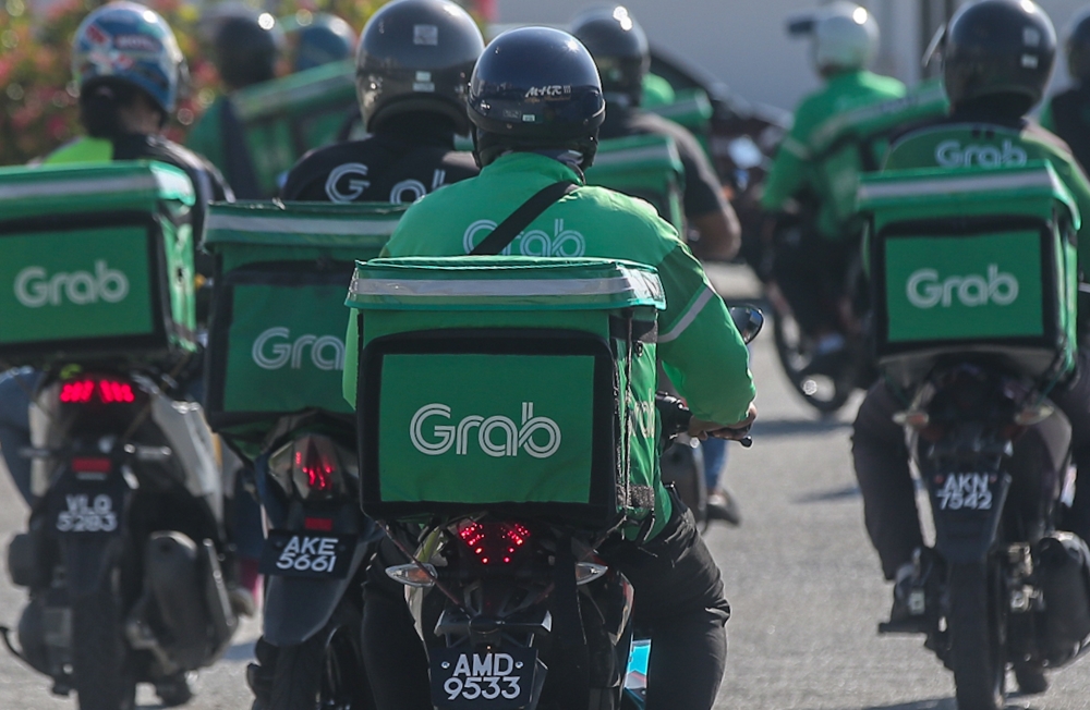 Just hours after attending the National Day celebrations in Putrajaya on Sunday, Grab CEO Anthony Tan travelled to Makassar to stand in solidarity with the Grab community in Indonesia. — Picture by Farhan Najib