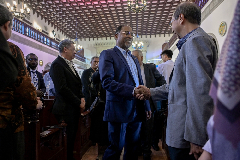 Higher Education Minister Datuk Seri Zambry Abdul Kadir greets guests after launching the Institute of Internationalization and Asean Studies (INTAS) and the book Education of the Interior: Essays in Honour of Professor Syed Ali Ashraf at the International Institute of Islamic Thought and Civilisation (ISTAC), IIUM Kuala Lumpur campus, today. — Bernama pic