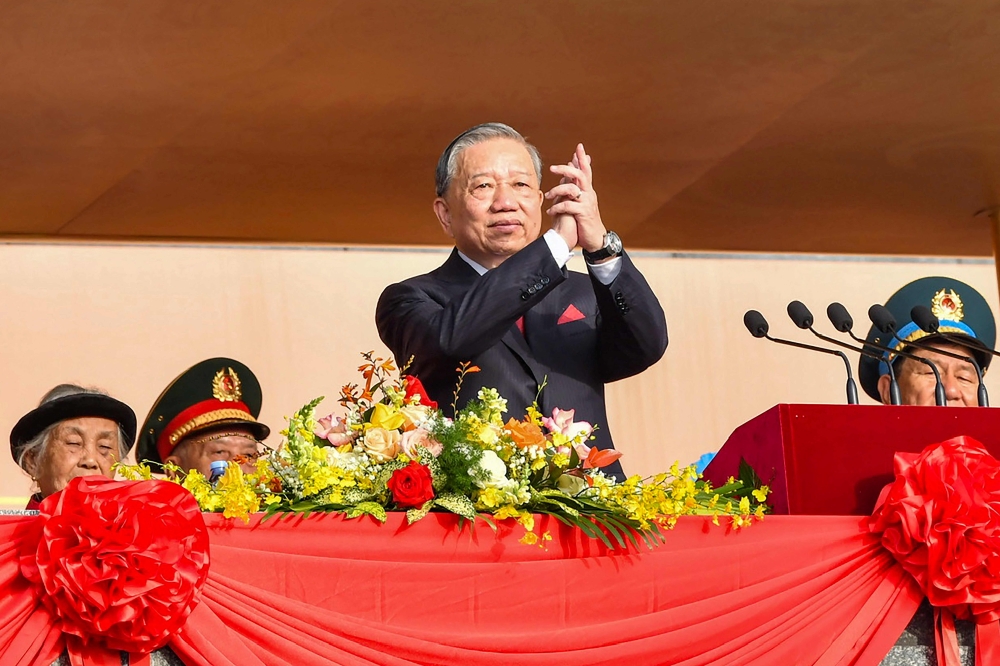 Vietnam's Communist Party General Secretary To Lam (centre) applauds during a parade marking Vietnam's 80th National Day celebrations in Hanoi on September 2, 2025. — AFP pic