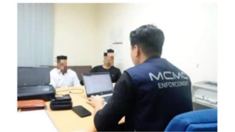 State Assemblyman (ADUN) for Manjoi, Mohd Hafez Sabri (in black shirt), has his statement recorded at the Royal Malaysia Police headquarters in Bukit Aman yesterday. — Picture courtesy of MCMC