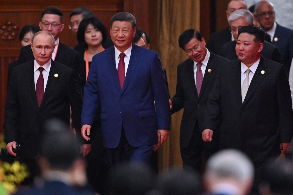 China’s President Xi Jinping (centre), North Korea’s leader Kim Jong Un (right) and Russia’s President Vladimir Putin (left) arrive for a reception at the Great Hall of the People in Beijing, following a military parade marking the 80th anniversary of Japan’s defeat and the end of World War II, on September 3. — AFP pic