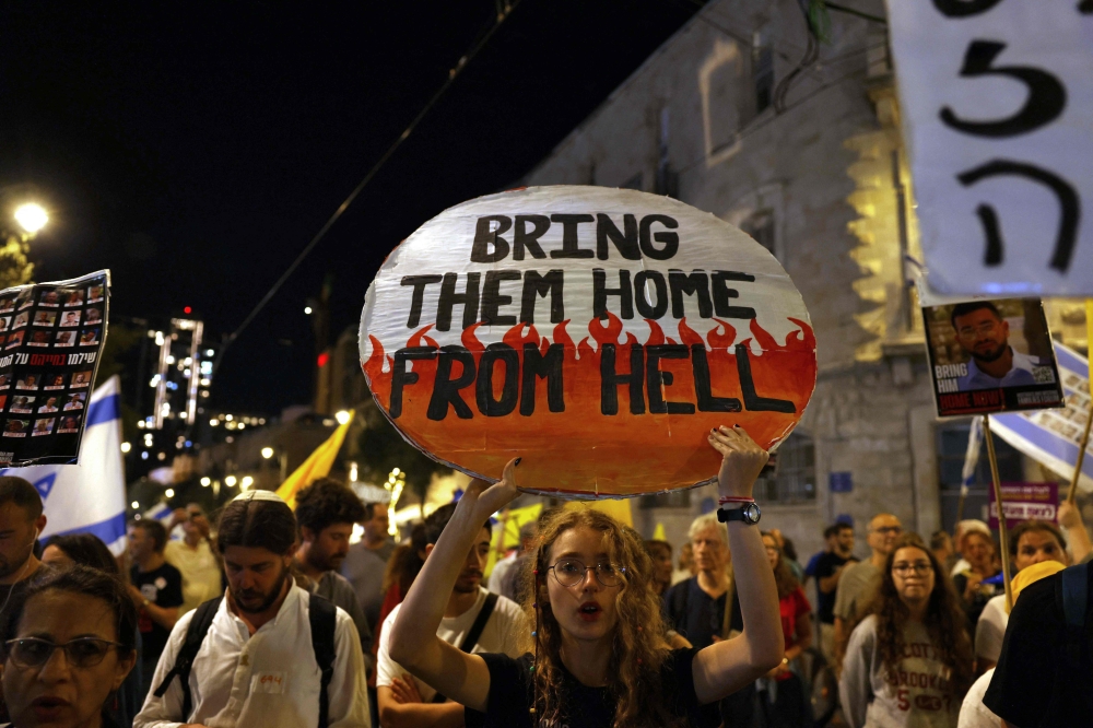 Protesters chant slogans during a demonstration organised by families of Israelis held hostage by Palestinian militants in Gaza, calling for their release and for a ceasefire in the war. — AFP pic