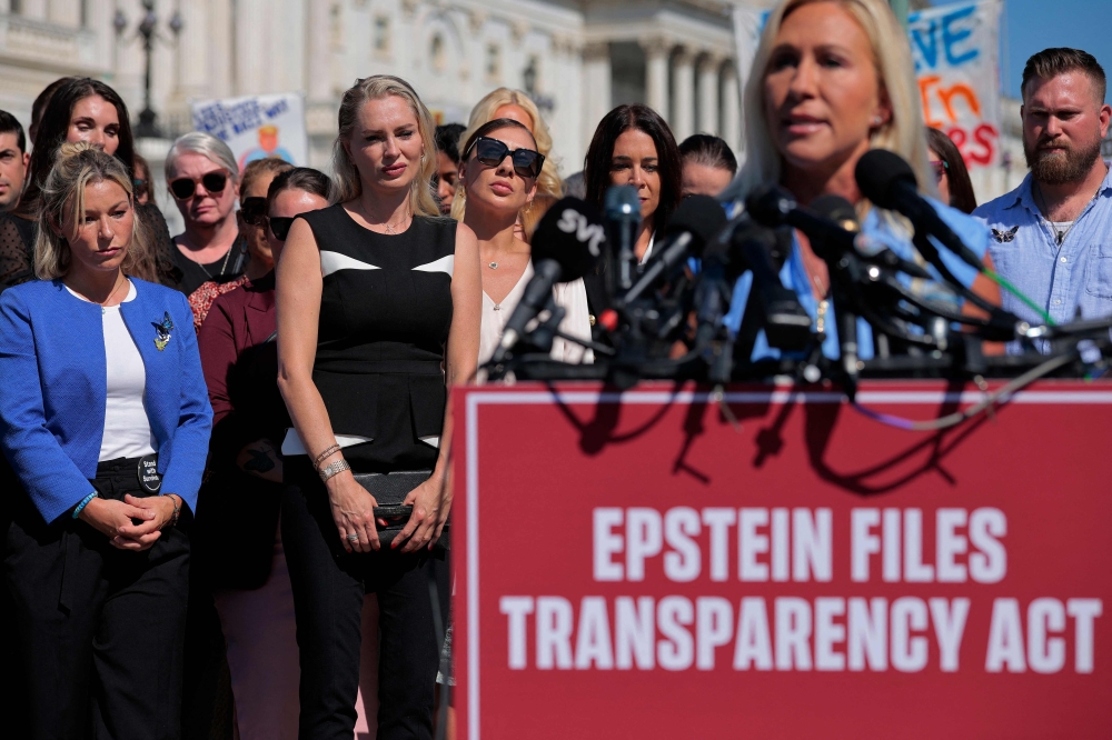 Some of Jeffrey Epstein's alleged victims, including (L-R) Danielle Bensky, Anouska De Georgiou, Marina Lacerda and others, listen to Rep. Marjorie Taylor Greene (R-GA) speak during a news conference with other survivors outside the US Capitol yesterday. — AFP pic 