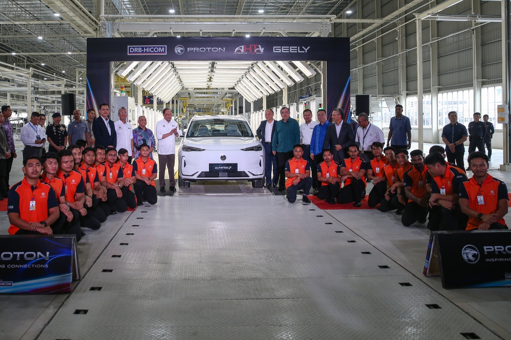 Prime Minister Datuk Seri Anwar Ibrahim (centre) poses for a group photo during the launch of Proton’s electric vehicle plant in Tanjung Malim, Perak, September 4, 2025. — Picture by Yusof Isa
