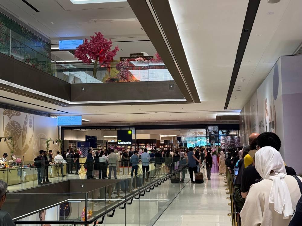 Excited Malaysians queued for the opening of the new outlet. — Picture by Erna Mahyuni