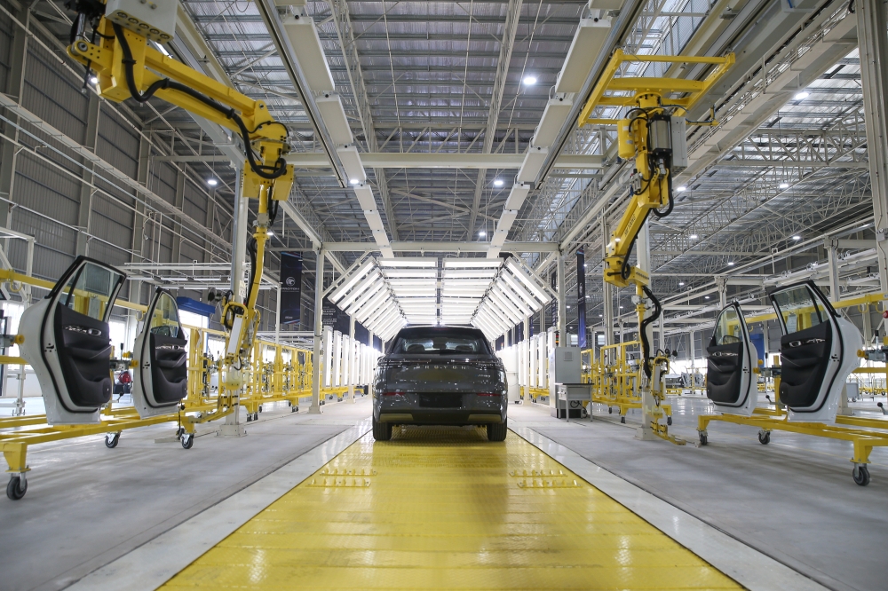 Automated systems installing car doors on the assembly line at Proton’s dedicated EV plant in Tanjung Malim, Perak, September 4, 2025. — Picture by Yusof Isa