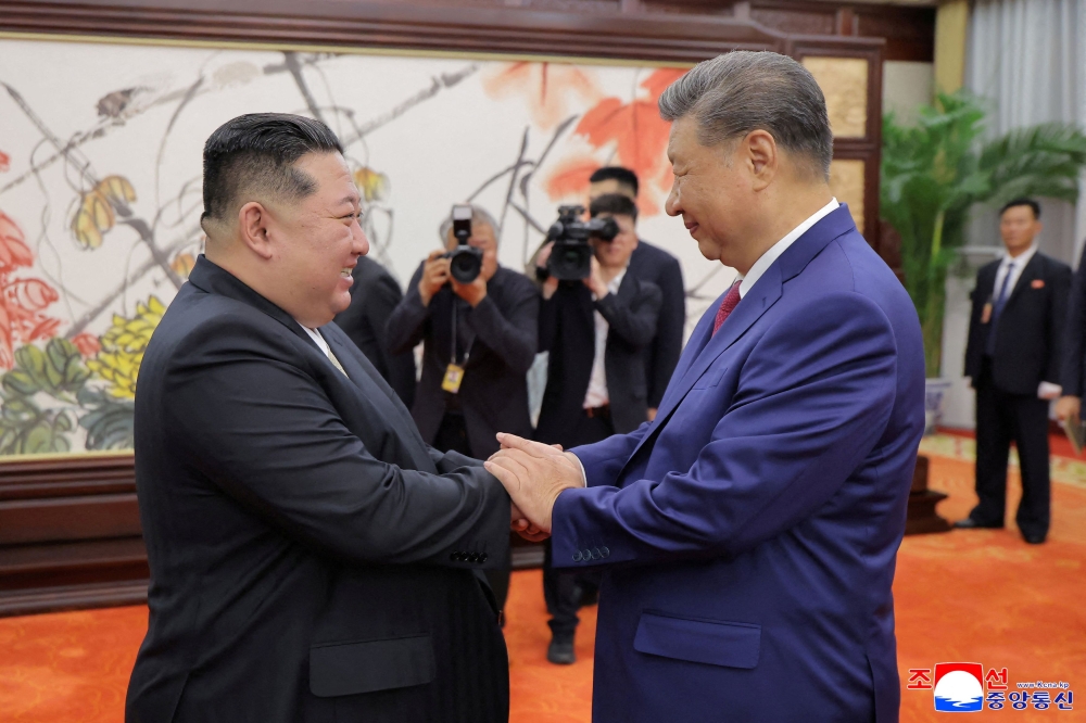 North Korean leader Kim Jong Un and Chinese President Xi Jinping shake hands on the day of their bilateral summit in Beijing September 4, 2025, in this picture released by North Korea’s official Korean Central News Agency. — KCNA pic via Reuters