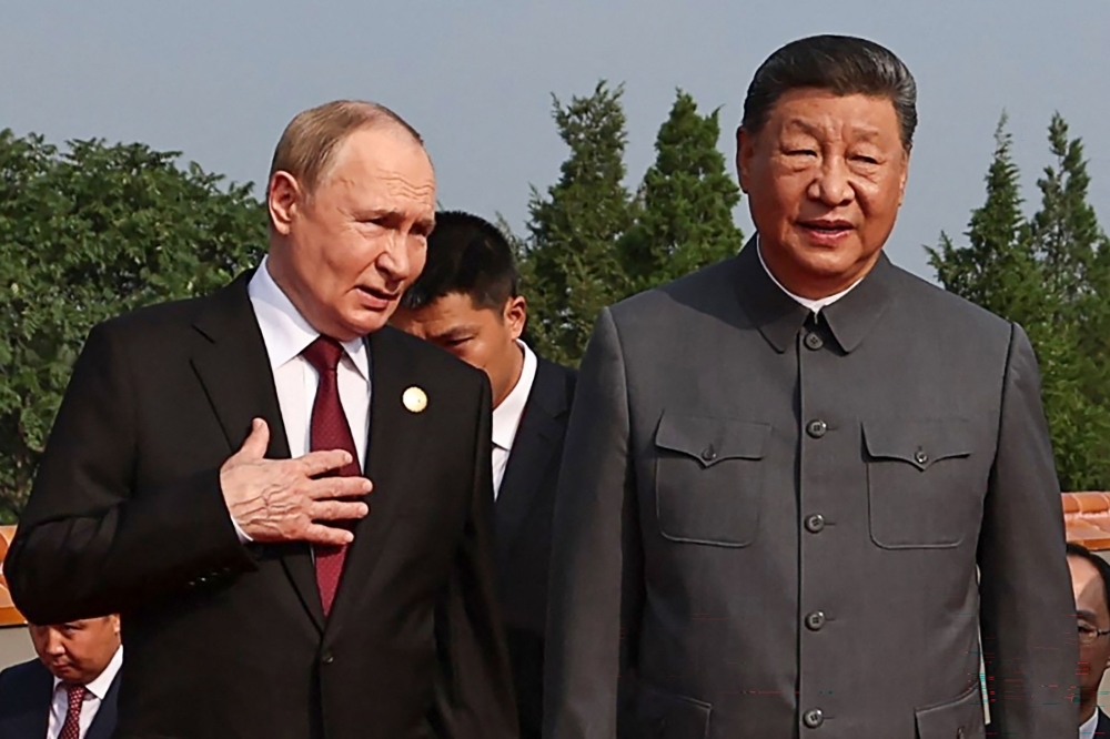 In this pool photograph distributed by the Russian state agency Sputnik, Russia’s President Vladimir Putin walks with China’s President Xi Jinping before a military parade marking the 80th anniversary of victory over Japan and the end of World War II, in Beijing’s Tiananmen Square on September 3, 2025. The conversation suggested that fending off the ravages of age was on the minds of Putin and Xi, who are both 72 and have not expressed any desire to step down. — AFP pic