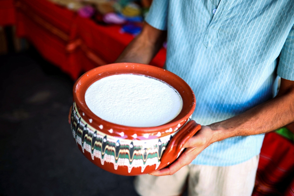 A local producer shows Bulgarian yogurt displayed during the Yogurt Festival in the village of Momchilovtsi, Bulgaria, August 30, 2025. — Reuters pic
