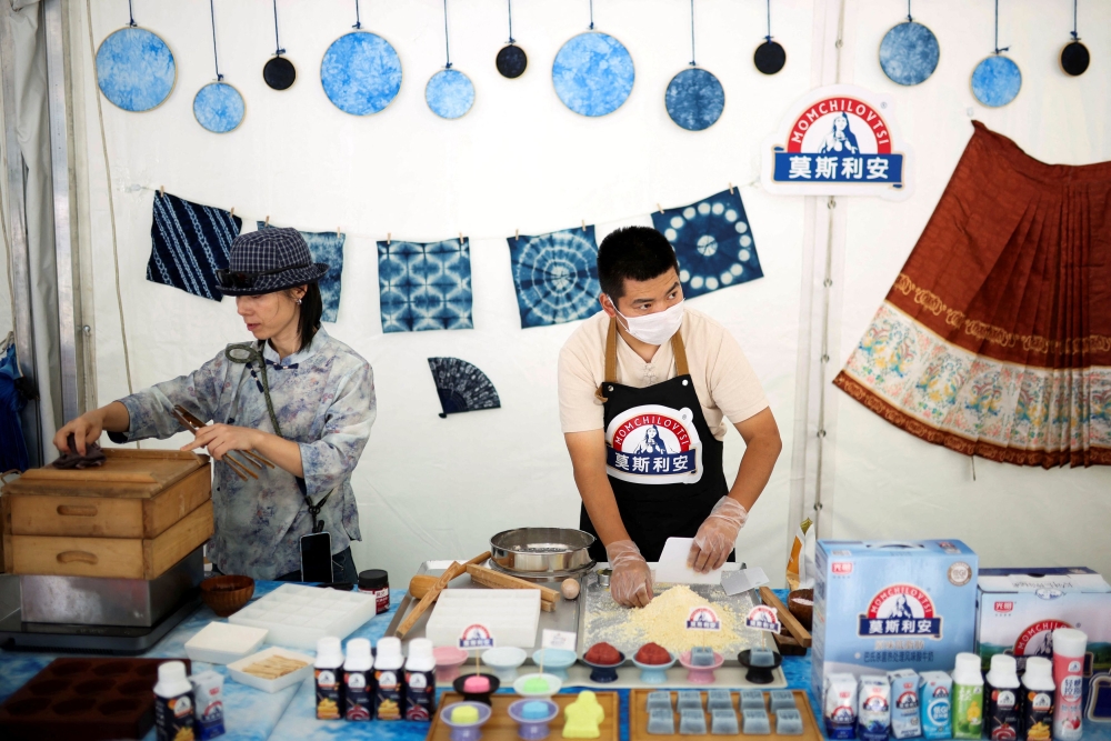 Chinese participants of the Yogurt Festival prepare a rice cake next to Chinese yogurt in the village of Momchilovtsi, Bulgaria, August 29, 2025. — Reuters pic