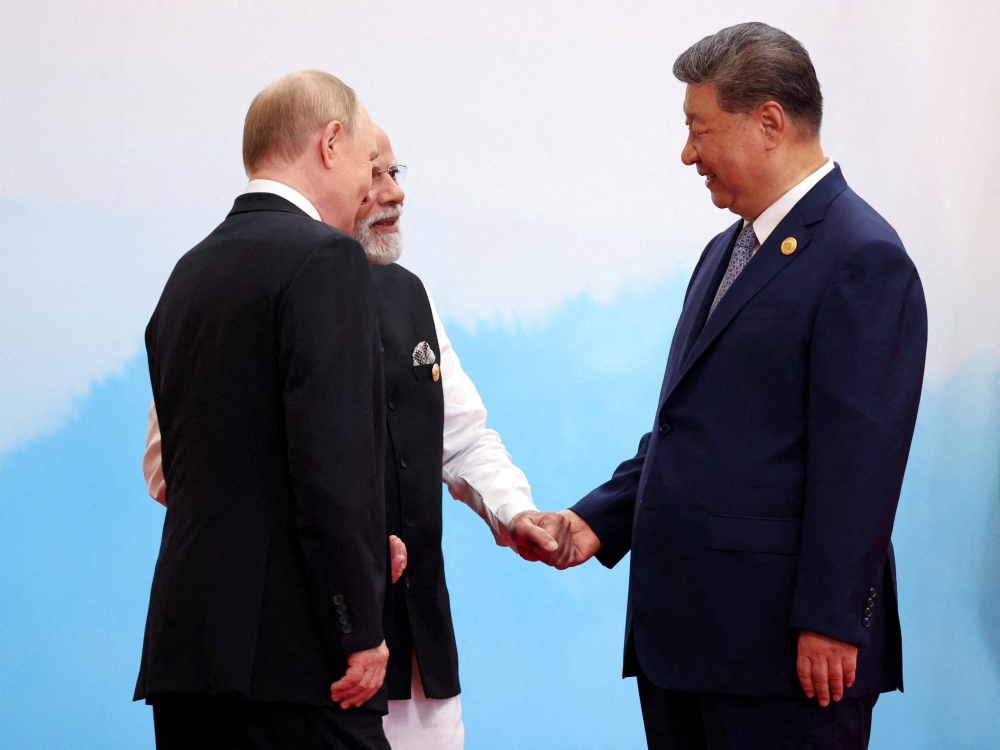 Chinese President Xi Jinping, Indian Prime Minister Narendra Modi and Russian President Vladimir Putin speak during a meeting at the Shanghai Cooperation Organisation (SCO) summit in Tianjin September 1, 2025. — Sputnik/Alexander Kazakov/Pool pic via Reuters 