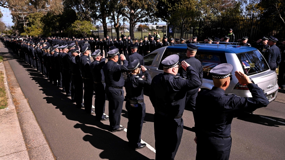 A police guard of honour salutes as the coffin of police officer Senior Constable Vadim de Waart-Hottart leaves the Victoria Police Academy chapel following a funeral service, in Melbourne on September 5, 2025. Around a thousand people have gathered for a funeral of de Waart-Hottart, one of two Victoria Police officers killed in a shooting at Porepunkah in Victoria's north-east last week. Suspected gunman Dezi Freeman fled into dense bushland on foot, sparking an enormous manhunt involving hundreds of police officers that is now in its 12th day. — AFP pic 