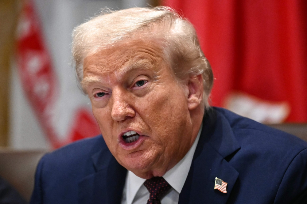 US President Donald Trump signed an executive order offering some tariff exemptions as soon as Monday to trading partners who strike deals on industrial exports such as nickel, gold and other metals, as well as pharmaceutical compounds and chemicals. — AFP pic 